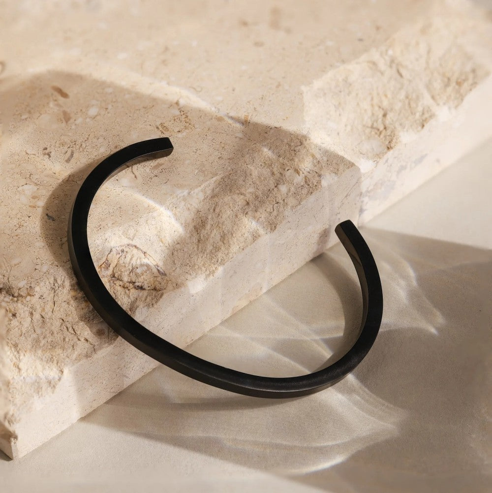 Slim Cuff - black cuff on stone block